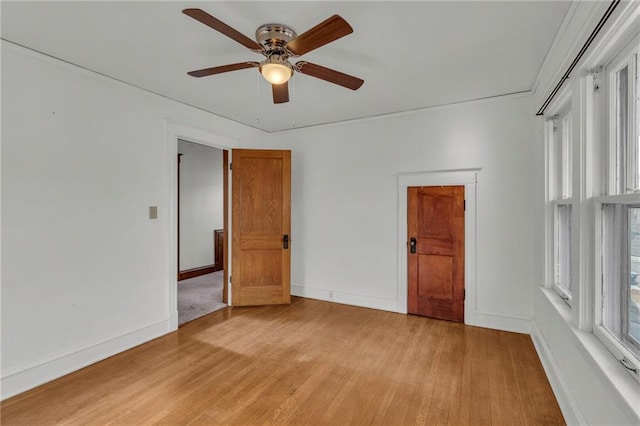 spare room featuring ceiling fan and light hardwood / wood-style flooring