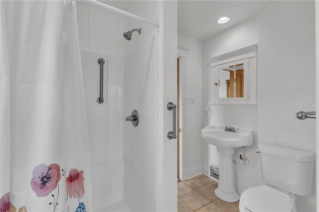 bathroom featuring tile patterned flooring, toilet, and a shower with shower curtain