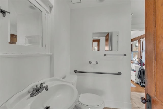 bathroom with tile patterned flooring, sink, and toilet