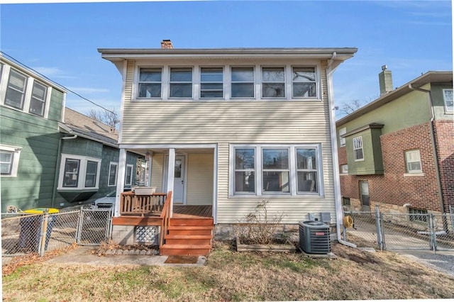 rear view of property with central AC