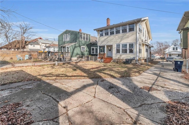 rear view of property with cooling unit