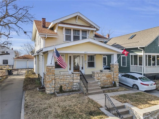 view of front of house with a garage, an outdoor structure, and covered porch