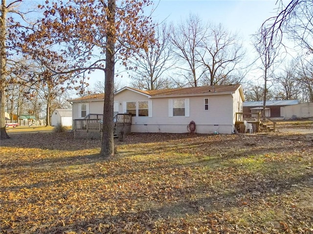 back of house with a wooden deck