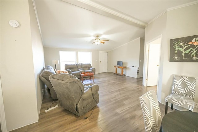 living room featuring hardwood / wood-style flooring, ornamental molding, and ceiling fan