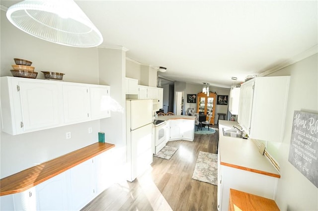 kitchen with white cabinetry, white appliances, kitchen peninsula, and pendant lighting