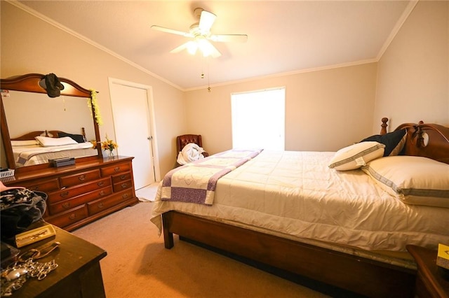 carpeted bedroom with crown molding, vaulted ceiling, and ceiling fan