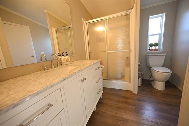 bathroom featuring toilet, vaulted ceiling, vanity, a shower with door, and hardwood / wood-style flooring