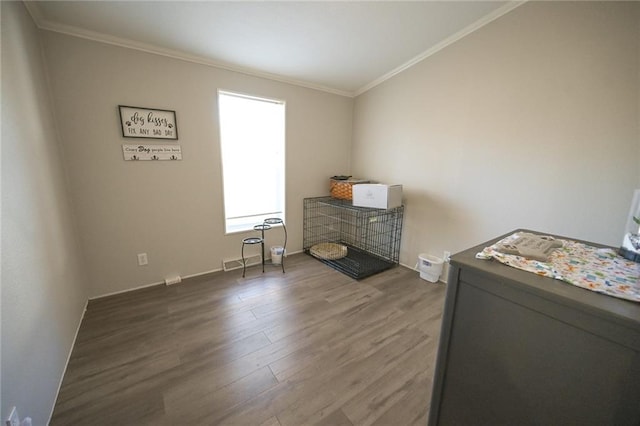 misc room with dark wood-type flooring and ornamental molding