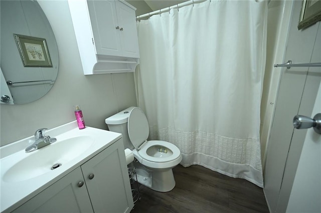 bathroom featuring a shower with curtain, wood-type flooring, toilet, and vanity