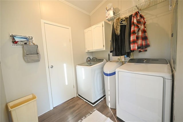 laundry room with cabinets, wood-type flooring, washer and dryer, and ornamental molding