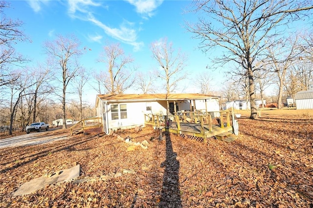 rear view of house featuring a deck