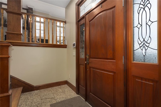 foyer entrance featuring baseboards