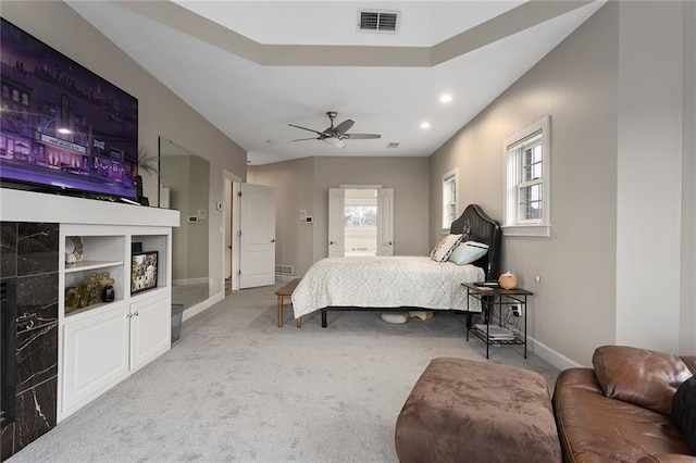 bedroom with carpet, visible vents, and multiple windows