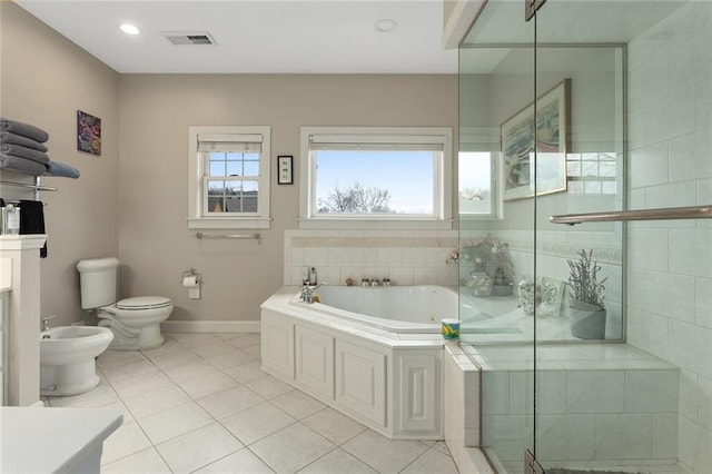 bathroom featuring a stall shower, toilet, tile patterned flooring, a bidet, and a bath