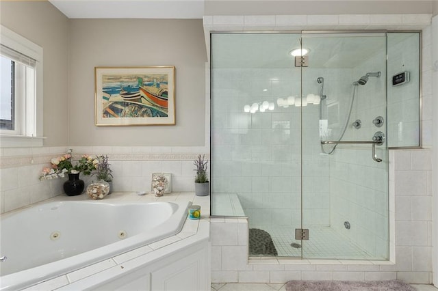 bathroom with a stall shower and a jetted tub