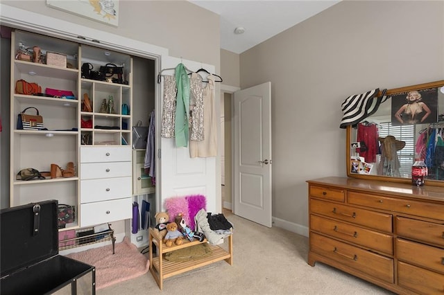 bedroom with baseboards and light colored carpet