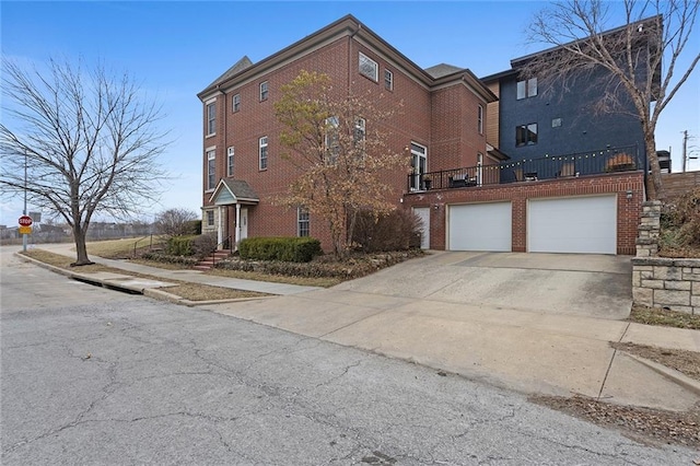 exterior space with driveway, an attached garage, and brick siding