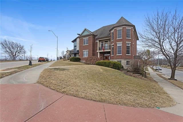 exterior space with a front yard and brick siding