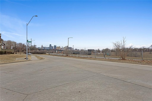 view of street with street lighting and curbs