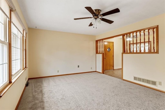 unfurnished room featuring light colored carpet and ceiling fan