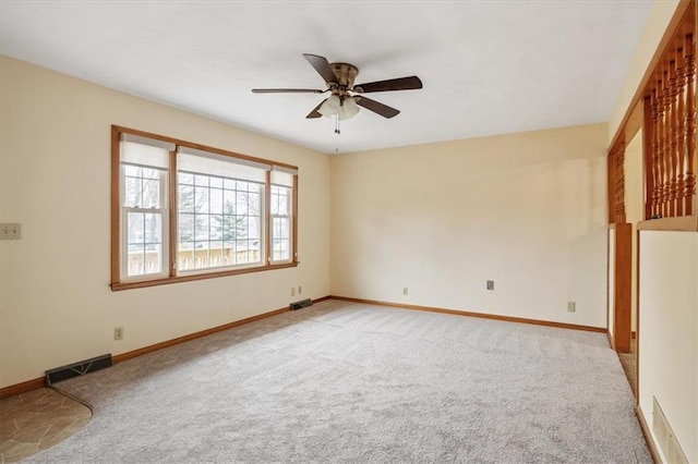 empty room with ceiling fan and light colored carpet