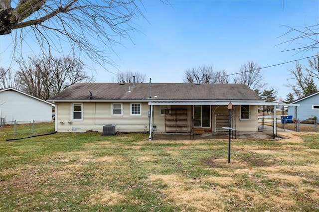 rear view of house with cooling unit, a yard, and a patio area