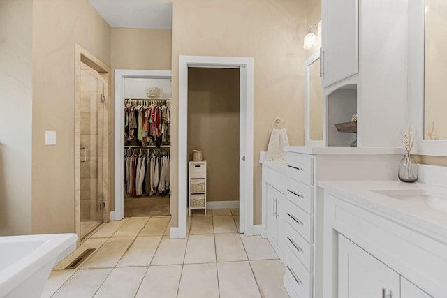 bathroom with walk in shower, tile patterned floors, and vanity