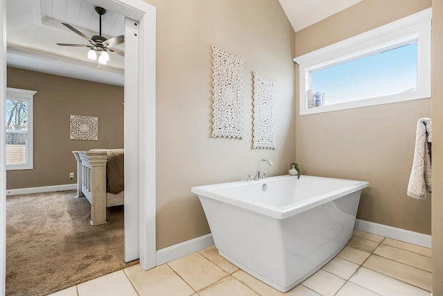 bathroom with ceiling fan, tile patterned floors, and a bathtub