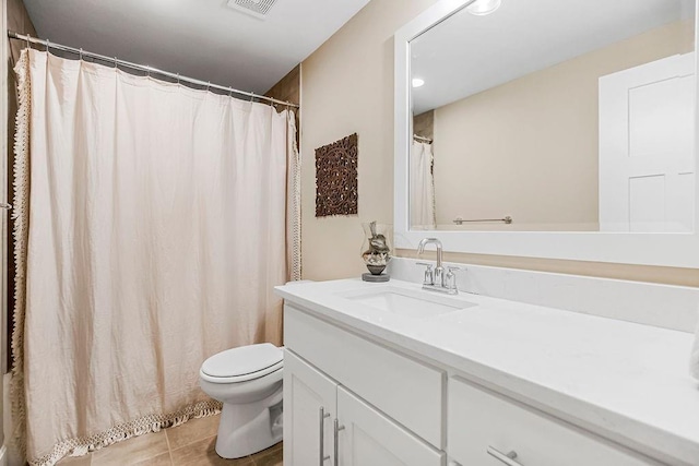 bathroom with vanity, tile patterned floors, and toilet