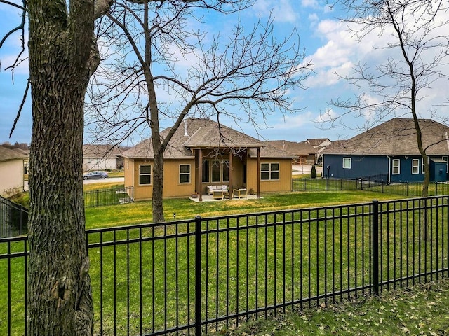 rear view of house with a lawn and a patio area