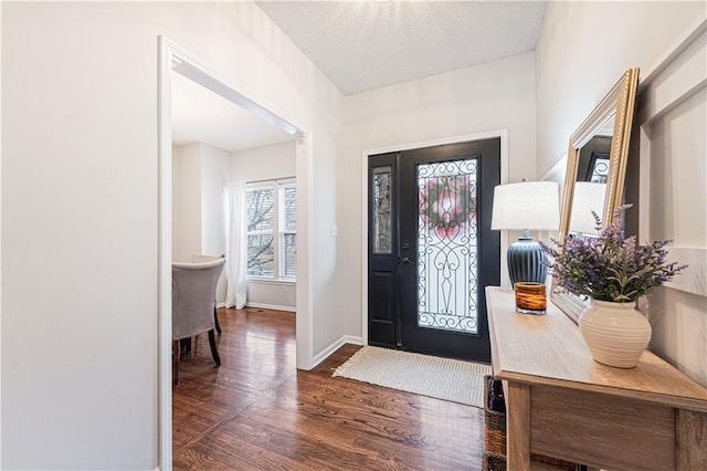 entryway with dark hardwood / wood-style floors and a textured ceiling