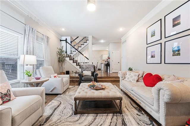 living room with wood-type flooring and ornamental molding