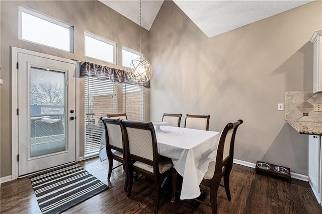 dining space with dark hardwood / wood-style floors and a towering ceiling