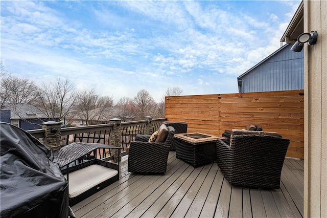 wooden terrace featuring a fire pit