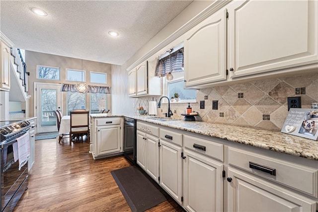 kitchen featuring sink, white cabinetry, backsplash, dark hardwood / wood-style floors, and stainless steel range with electric cooktop