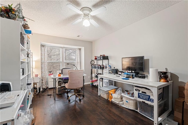 office area with ceiling fan, dark hardwood / wood-style flooring, and a textured ceiling