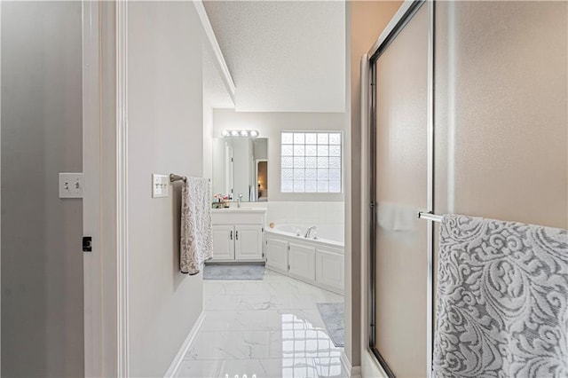 bathroom featuring vanity, separate shower and tub, and a textured ceiling