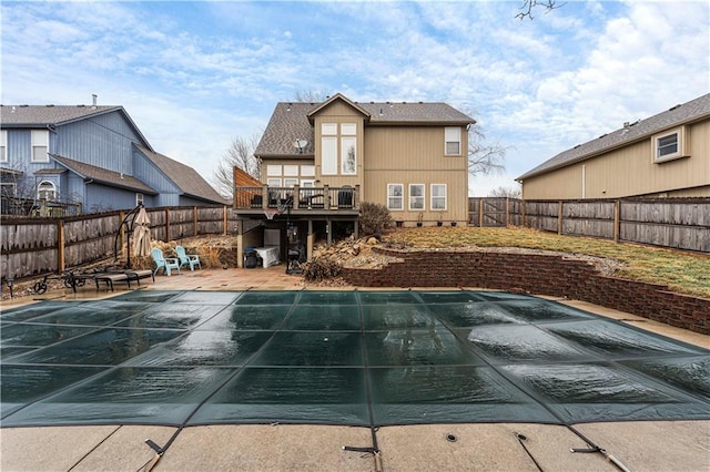 view of pool with a wooden deck and a patio area