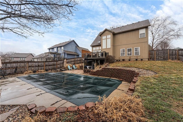 view of pool featuring a patio area, a deck, and a lawn