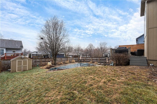 view of yard with a covered pool and a shed