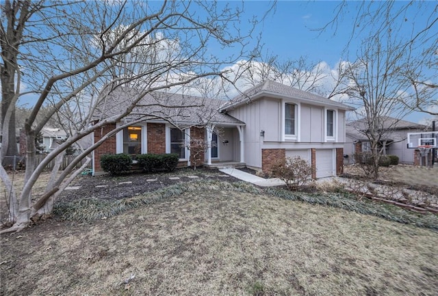 tri-level home featuring a garage and a front yard