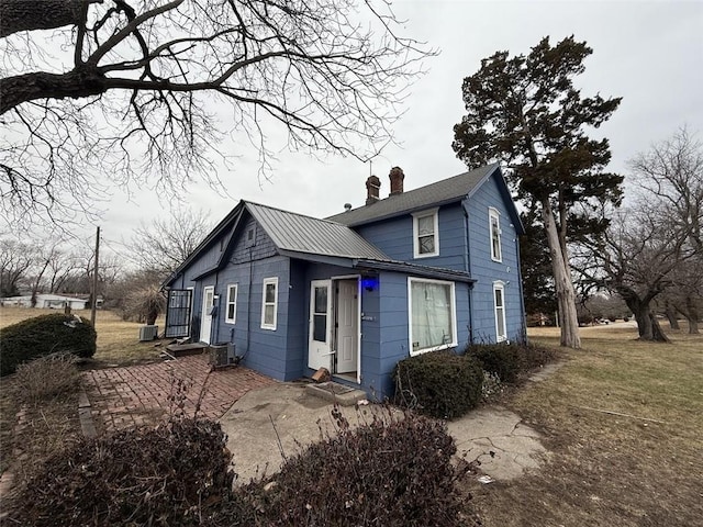 view of front of home featuring central AC unit and a patio