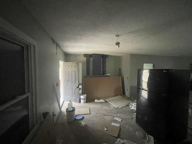 interior space featuring a textured ceiling