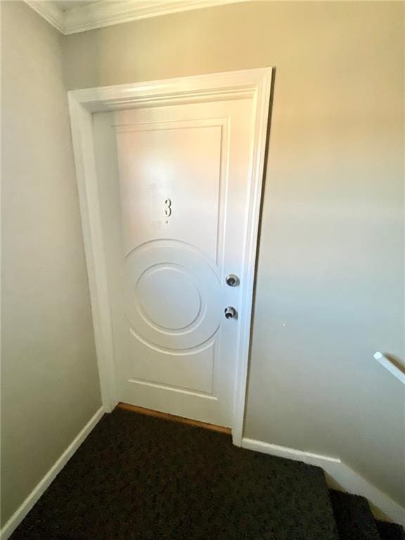 doorway to outside featuring dark colored carpet