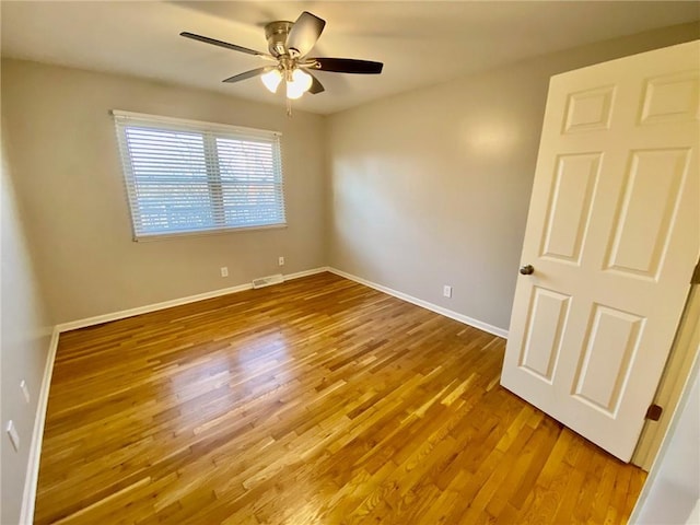 unfurnished room with hardwood / wood-style flooring and ceiling fan