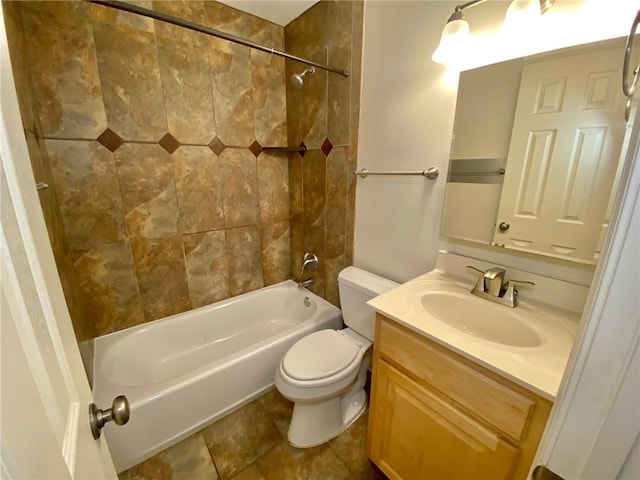 full bathroom with tiled shower / bath combo, vanity, and toilet