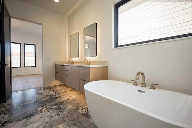 bathroom featuring vanity and a tub to relax in