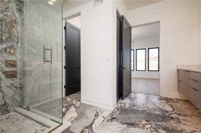 bathroom featuring vanity and an enclosed shower