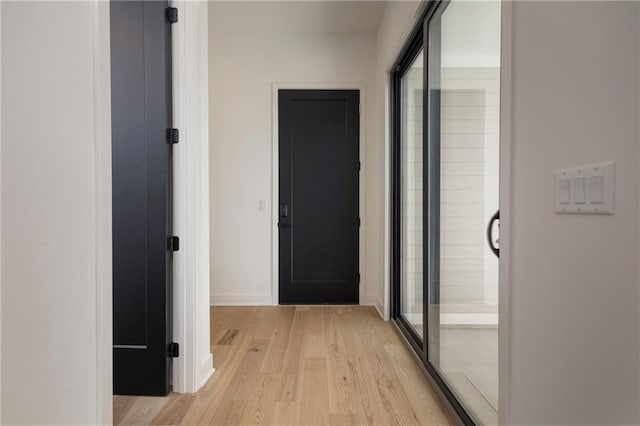 corridor with light hardwood / wood-style flooring