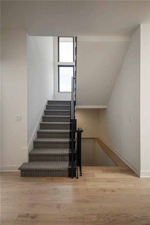 stairs featuring hardwood / wood-style flooring